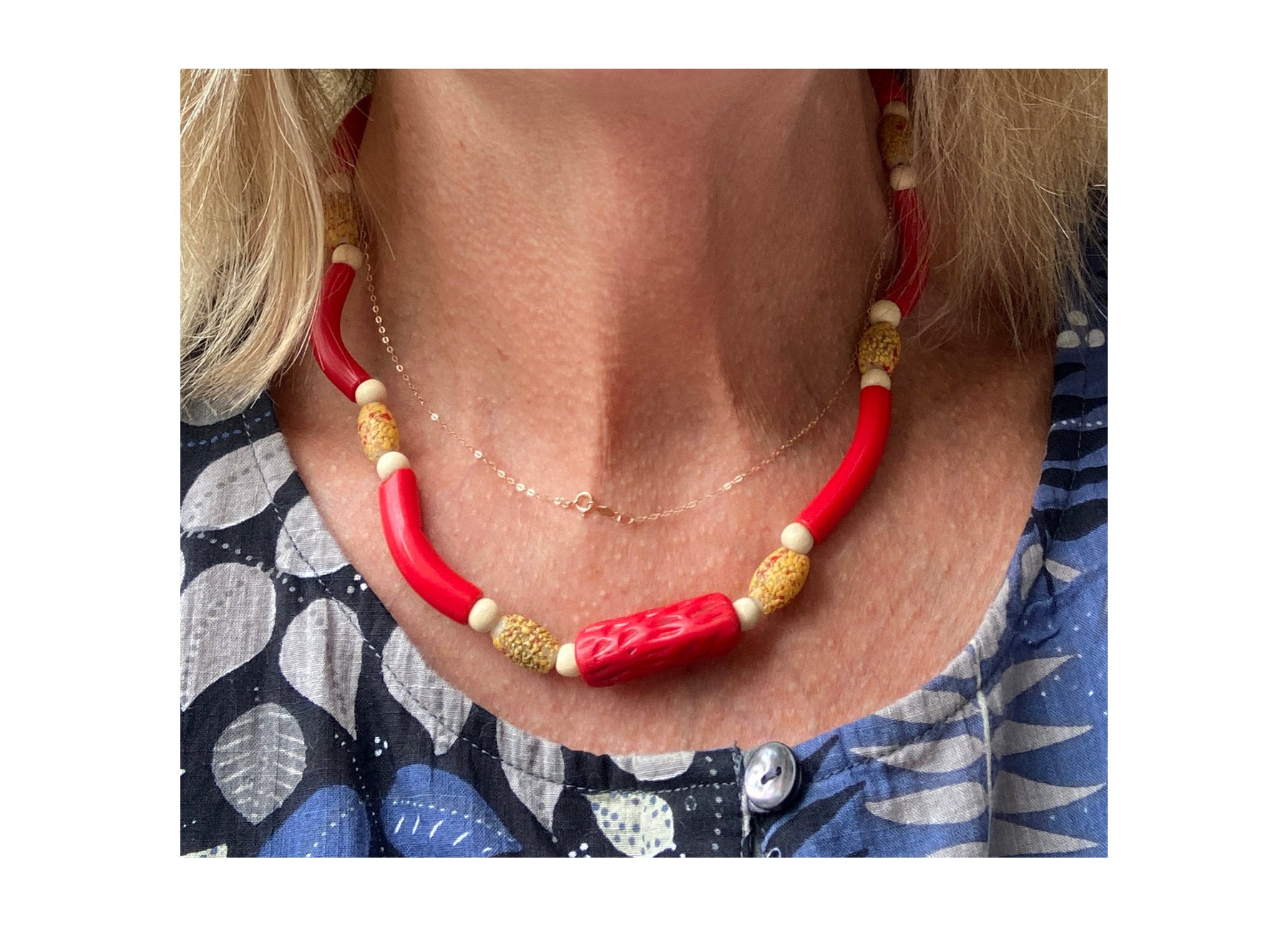 Single strand necklace of red antique Czech curved glass tube beads,  antique Venetian textured and crackled yellow and red oval shaped trade  beads, biconal coconut wood beads, with central rarely. seen antique